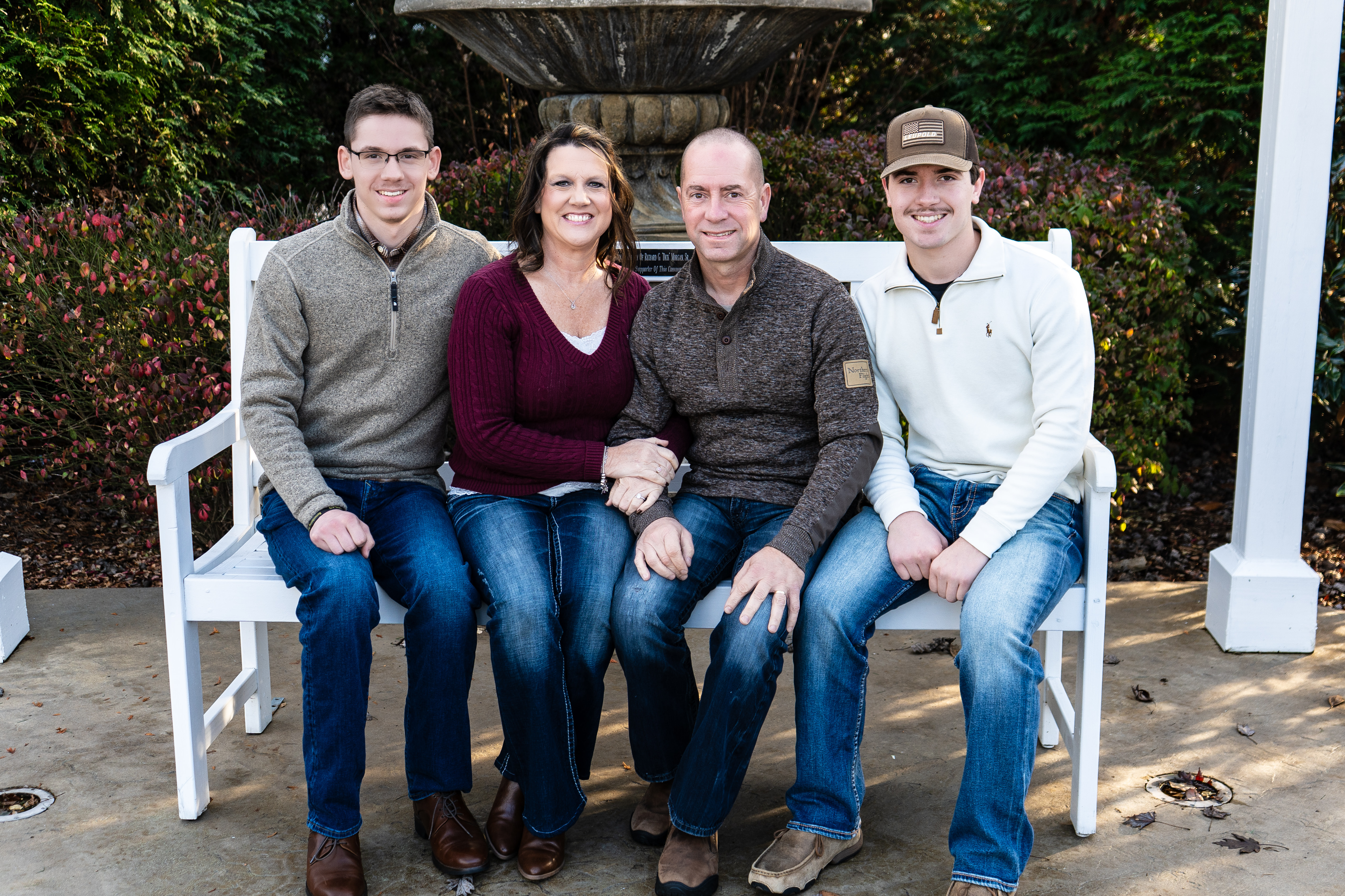 Family photo sitting on a bench outdoors